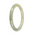 A pale green jadeite jade bangle with a dark green pattern, certified Grade A. The bangle has a half moon shape and measures 59mm in diameter. Sold by MAYS.