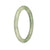 A small round jade bangle with genuine Type A Green and Apple Green Spots, measuring 56mm in size. Sold by MAYS GEMS.