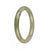 A small round olive green jadeite bangle with a high grade of quality, perfect for accessorizing with elegance and style.