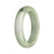 A beautiful jade bangle with green and lavender hues, featuring apple green spots.