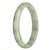 An exquisite, authentic Burma Jade bangle in a mesmerizing combination of green and white hues. The bangle is meticulously crafted, featuring a 79mm half moon shape. Perfect for adding a touch of elegance and natural beauty to any outfit.