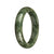 A close-up photo of a half-moon shaped, green pattern jade bracelet with an authentic grade A quality. The bracelet measures 59mm in diameter and is sold by MAYS.