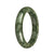 A close-up image of an authentic Type A Green Pattern Jade Bangle, specifically a 59mm size in a half moon shape. The bangle is made of genuine jade with a beautiful green pattern. It is a high-quality piece from the MAYS™ collection.