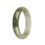 A stunning Burmese Jade bangle bracelet featuring a Real Grade A White and Light Green with Olive Green Patterns. The bracelet is shaped like a 54mm Half Moon and is a beautiful addition to any jewelry collection. From MAYS™.