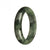 A close-up image of an authentic Type A Green Jade Bangle Bracelet with dark green patterns. The bracelet is a traditional style and has a 57mm diameter in a half moon shape. This piece is from the MAYS collection.