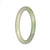 A small round jade bangle in natural light green and pale green colors.