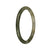 A dainty round jade bracelet featuring a mix of natural grey and olive green colors, adorned with brown spots.