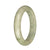 A beautiful traditional jade bangle bracelet with a light grey and pale green color, featuring a deep green spot. The bracelet is in a half moon shape and measures 58mm.