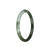 A petite round jade bracelet in olive green and white colors, featuring a traditional design.