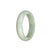 A beautiful pale green and white jadeite bangle bracelet with a half moon design, certified Grade A quality.