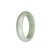 A half moon-shaped, Grade A pale green and white jade bangle with an authentic and exquisite design by MAYS.