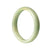 A half moon-shaped bangle bracelet made of genuine untreated green Burma jade, measuring 55mm in diameter.