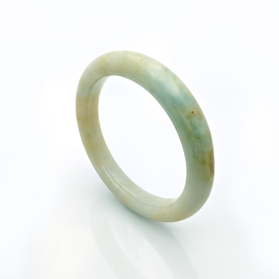 A close-up photo of an authentic pale green jade bangle with a semi-round shape, measuring 57mm in diameter. The bangle has a smooth and polished surface, showcasing the natural beauty of the jadeite jade. Created by MAYS GEMS, this bangle is a stunning piece of jewelry.