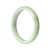 A light green traditional jade bangle with a half moon shape, made from high-quality grade A jade.