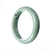 An elegant and high-quality pale green jadeite jade bangle in a half moon shape, measuring 64mm. Perfect for adding a touch of sophistication to any outfit.
