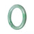 A close-up image of a round green jade bracelet with a smooth polished surface. The bracelet is made from certified Grade A jade and measures 58mm in diameter. It is a product by MAYS™.