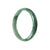 A close-up image of an elegant green jadeite bangle bracelet with a half-moon shape, measuring 59mm in diameter. The bracelet is made of authentic Grade A jadeite, known for its beautiful color and high quality. The brand name "MAYS" is also mentioned, possibly indicating the designer or manufacturer of the bracelet.