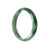 A half-moon shaped grade A green traditional jade bangle, measuring 59mm in size, made by MAYS™.