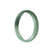 A half-moon shaped genuine natural green jadeite bangle bracelet, measuring 56mm in diameter, offered by MAYS GEMS.