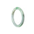 A close-up photo of a round, green jade bangle for children. The bangle is made of genuine, high-quality Grade A jade and has a traditional design. It is sold by MAYS GEMS.