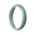 A pale green Burma Jade bangle bracelet with a half-moon shape, untreated and authentic, offered by MAYS GEMS.