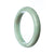 A beautiful green jadeite bangle with a semi-round shape, measuring 76mm in diameter. The bangle is made of genuine grade A jadeite and is a stunning addition to any jewelry collection.